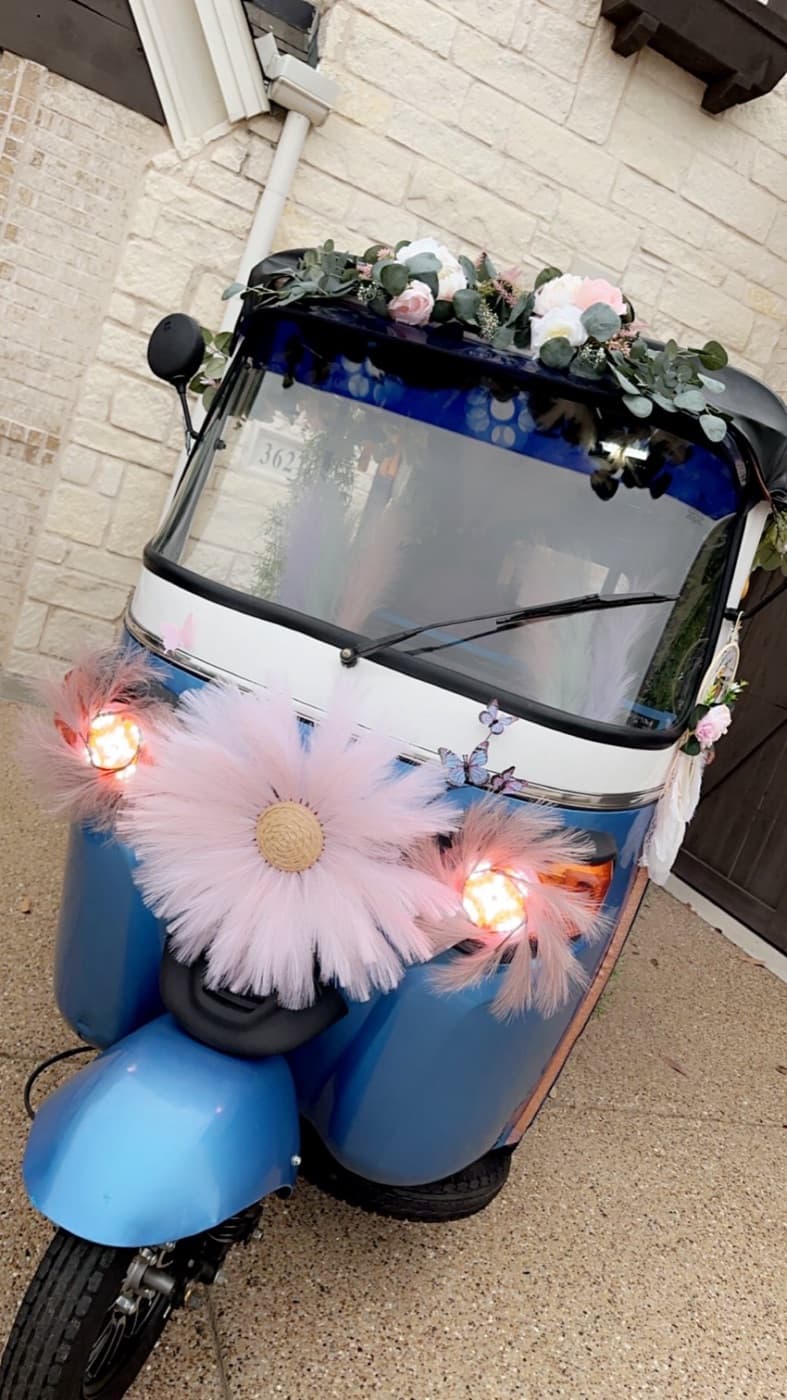Electric rickshaw dressed in florals and lights, one of the decoration options for a DFW event