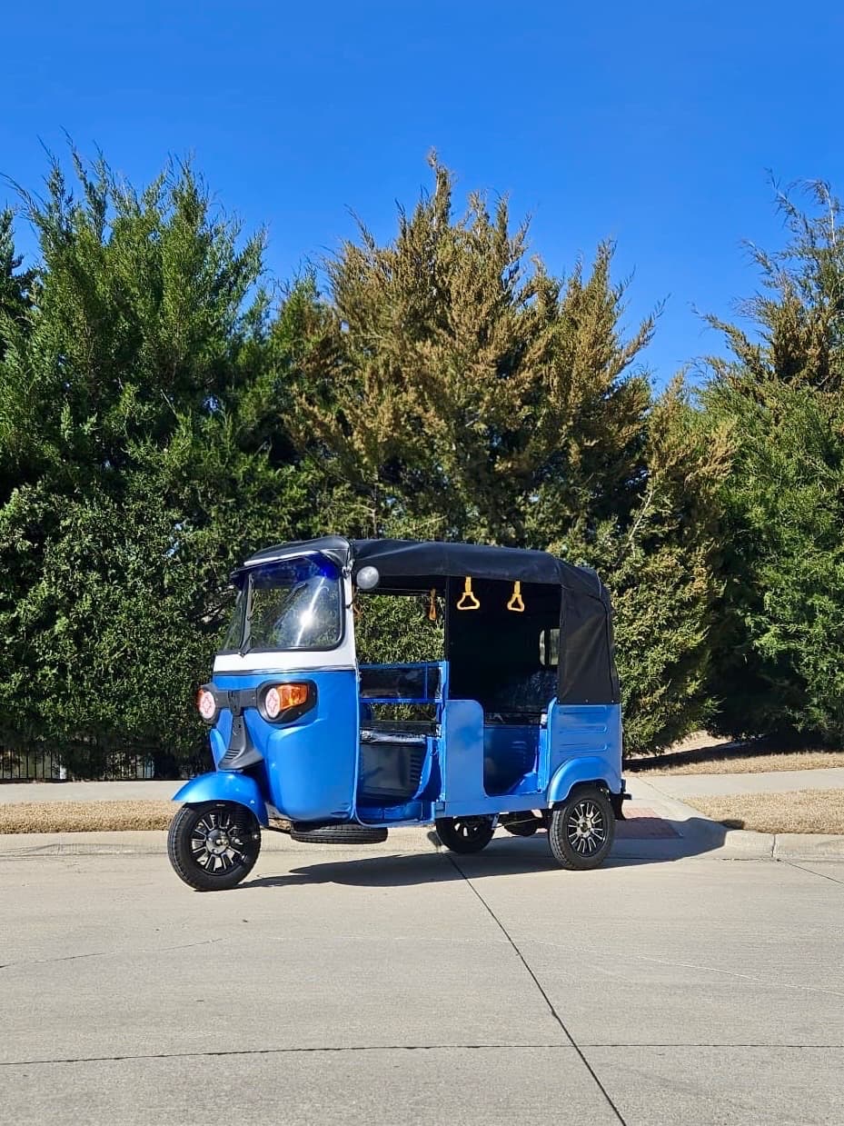 The electric rickshaw parked on a driveway, showing the footprint a DFW wedding venue is asked to allow